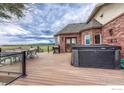 Large deck with hot tub, patio furniture, and scenic views at 1820 S State Highway 83, Franktown, CO 80116