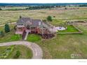 Brick home with landscaped yard and a long driveway at 1820 S State Highway 83, Franktown, CO 80116