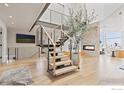 Modern open staircase with metal railings in a spacious foyer at 1145 Timber Ln, Boulder, CO 80304