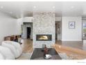 Living room with modern stone fireplace and hardwood floors at 1145 Timber Ln, Boulder, CO 80304