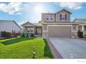 Two-story house with a two-car garage and landscaped front yard at 1851 Lochmore Dr, Longmont, CO 80504