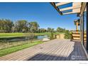 Large deck overlooking a pond and golf course at 923 Saint Andrews Ln, Louisville, CO 80027