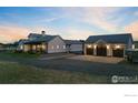 Modern farmhouse exterior with attached and detached garages at 560 Talons Reach Run, Berthoud, CO 80513