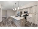 Open concept kitchen featuring light wood cabinets and an island at 310 S Cherrywood Dr # 301, Lafayette, CO 80026