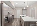 Modern kitchen with stainless steel appliances and an island at 310 S Cherrywood Dr # 301, Lafayette, CO 80026