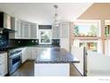 Modern kitchen with white cabinets and granite countertops at 4663 Quail Creek Ln, Boulder, CO 80301