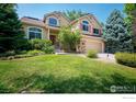 Two story house with a large front yard and attached garage at 4663 Quail Creek Ln, Boulder, CO 80301