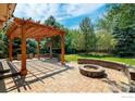 Backyard patio with fire pit and pergola at 4663 Quail Creek Ln, Boulder, CO 80301