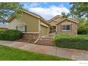 Two-story house with a green facade, stone accents, and a two-car garage at 22931 E Roxbury Dr # C, Aurora, CO 80016