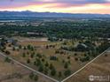 Aerial view of expansive property with mountain views and white fencing at 160 Ponderosa Dr, Boulder, CO 80303