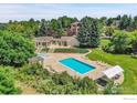 Community pool with surrounding landscaping and seating at 598 Brainard Cir, Lafayette, CO 80026