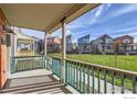 View from front porch showing a community of colorful homes and a grassy area at 10231 E 62Nd Pl, Denver, CO 80238