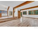 Spacious living room with hardwood floors, exposed beams, and large windows at 926 Mountain Meadows Rd, Boulder, CO 80302