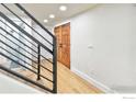 Modern staircase with sleek metal railing and light wood floors at 6107 Old Brompton Rd, Boulder, CO 80301