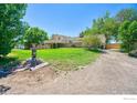 Ranch home with deck, yard, and gravel driveway at 19150 E 195Th Ave, Hudson, CO 80642