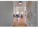 Bright entryway with hardwood floors and views into the living room at 958 Eldorado Ln, Louisville, CO 80027