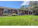 Brick patio with seating area and lush green lawn at 5067 Cottonwood Dr, Boulder, CO 80301