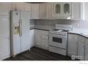 Bright kitchen featuring white cabinets and modern appliances at 150 5Th St, Fort Lupton, CO 80621