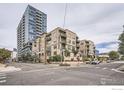 Exterior view of the building from the street corner with a tall building in the background at 1200 Cherokee St # 206, Denver, CO 80204
