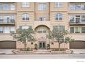 Exterior of a three-story building with balconies, garages, and landscaping at 1200 Cherokee St # 206, Denver, CO 80204