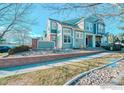 Townhouse exterior, two-story, light gray siding at 13900 Lake Song Ln, Broomfield, CO 80023