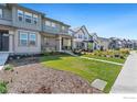 Row of two story townhomes with front yards at 2423 Whistler Dr, Longmont, CO 80504