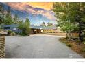 Modern home with stone accents and a spacious driveway, offering curb appeal at 271 Anemone Dr, Boulder, CO 80302