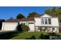 House exterior with a two-car garage and landscaping at 177 S Polk Ave, Louisville, CO 80027