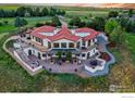 Luxury home with terracotta roof, expansive patio, and mountain views at 8758 W Phillips Rd, Boulder, CO 80301