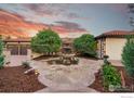Elegant courtyard entry with a stone fountain and landscaping at 8758 W Phillips Rd, Boulder, CO 80301