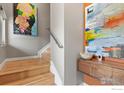 Modern light-filled staircase with wood floors and artwork at 327 E Simpson St, Lafayette, CO 80026