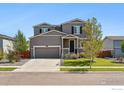 Two-story house with gray siding, attached garage, and landscaping at 6112 Black Mesa Rd, Frederick, CO 80516