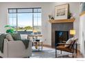 Bright living room with fireplace, large windows, and comfortable seating at 3766 Ridgeway St, Boulder, CO 80301