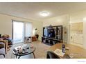 Open living area with dining space and kitchen view at 8047 Wolff St # F, Westminster, CO 80031