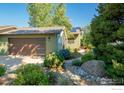 Charming house exterior with a large garage and landscaped yard at 1095 Quince Ave, Boulder, CO 80304