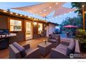 Backyard patio with seating area, string lights, and a grill at 1600 Alpine Ave, Boulder, CO 80304