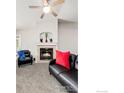 Living room with fireplace, black leather sofa and chair at 2931 Whitetail Cir # 2931, Lafayette, CO 80026