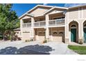 Three-unit townhome building with attached garages and balconies at 2931 Whitetail Cir # 2931, Lafayette, CO 80026