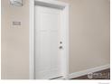 White apartment door with number 104 at 290 S Cherrywood Dr # 104, Lafayette, CO 80026