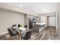 Kitchen dining area with glass table and four gray chairs at 290 S Cherrywood Dr # 104, Lafayette, CO 80026