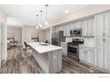 Modern kitchen with white cabinetry, stainless steel appliances and island at 290 S Cherrywood Dr # 104, Lafayette, CO 80026
