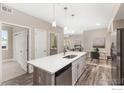 Modern kitchen with island, stainless steel appliances, and light-colored cabinetry at 290 S Cherrywood Dr # 204, Lafayette, CO 80026