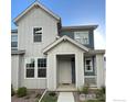 Two-story home with gray and white siding and front porch at 1905 Shoshone Pl, Broomfield, CO 80023