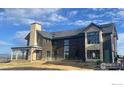 Under construction, two-story home with stone and wood exterior, solar panels, and mountain view at 917 Latigo Loop, Lafayette, CO 80026