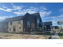 Under construction home showcasing a side view, stone and wood exterior at 917 Latigo Loop, Lafayette, CO 80026