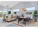 Open concept living and dining area with vaulted ceilings, and large windows at 751 W Grange Ct # B, Longmont, CO 80503