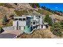 Luxury home on a hillside with mountain views and driveway at 230 S Cedar Brook Rd, Boulder, CO 80304