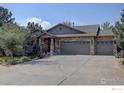 Two-story house with stone and siding exterior, three-car garage at 2690 Forsythia Ct, Erie, CO 80516