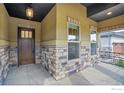 House entrance with stone facade and wooden door at 365 Casalon Pl, Superior, CO 80027