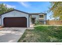 House exterior, light blue siding, brown garage door and landscaping at 1900 Logan St, Longmont, CO 80501